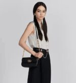 like the 30 Montaigne signature embossed on the back and the signature chain alternating gold-finish metal and tonal enamel links that match the leather. The gusseted bag features a spacious and refined silhouette that can be carried by hand