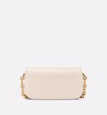 the rounded flap with delicate curves is punctuated by an antique gold-finish metal CD clasp inspired by the seal of a Christian Dior perfume bottle. The design is completed by other details