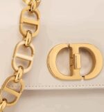 like the 30 Montaigne signature embossed on the back and the signature chain alternating gold-finish metal and tonal enamel links that match the leather. The gusseted bag features a spacious and refined silhouette that can be carried by hand
