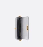 the rounded flap with delicate curves is punctuated by an antique gold-finish metal CD clasp inspired by the seal of a Christian Dior perfume bottle. The design is completed by other details
