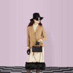 the accessory is further accentuated by two decorative leather belts