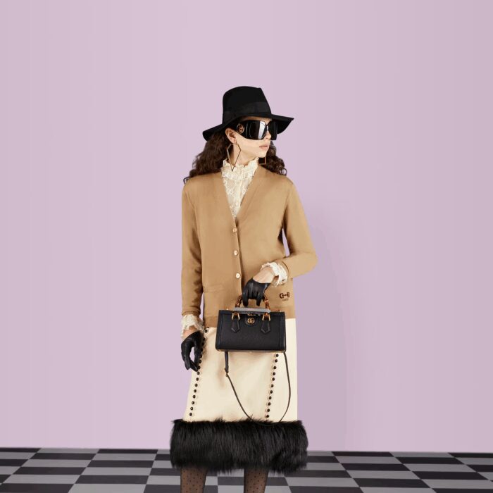 the accessory is further accentuated by two decorative leather belts