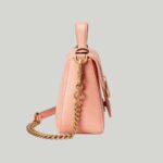 crafted in matelassé leather following curved lines.