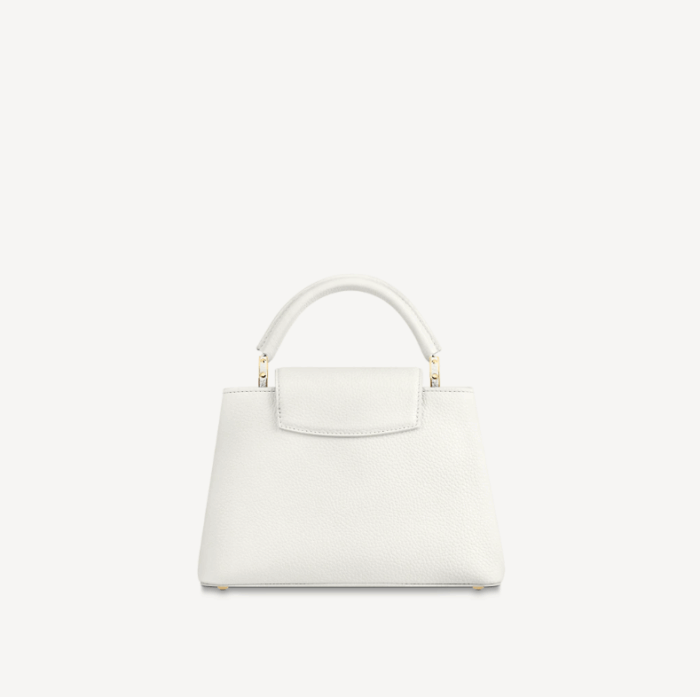 the now-classic Capucines BB handbag displays a host of House signatures: leather-wrapped LV Initials