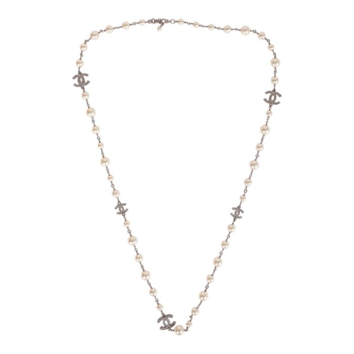 This imitation pearl long necklace features a crystal CC logo pendant throughout with an adjustable lobster claw clasp.