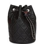 This mini bucket bag is of black lambskin with silver tone hardware and has the signature diamond quilting