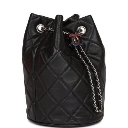 This mini bucket bag is of black lambskin with silver tone hardware and has the signature diamond quilting