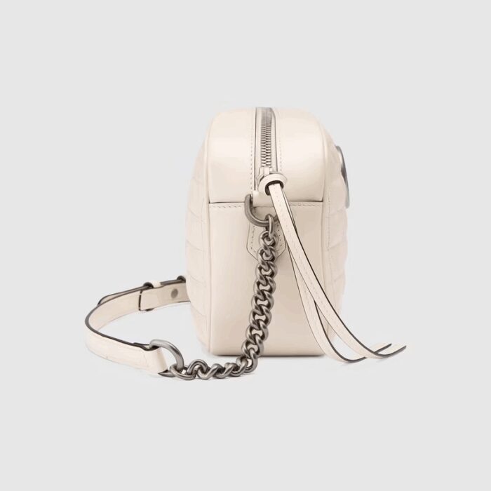 the style is reimagined with a new geometric approach to the signature material while its Double G hardware is presented with an antique silver-toned finish. The design appears here in the shape of a small shoulder bag in white.