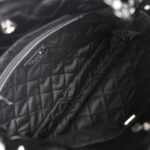The interior is lined in black fabric with one zip pocket on the rear wall.