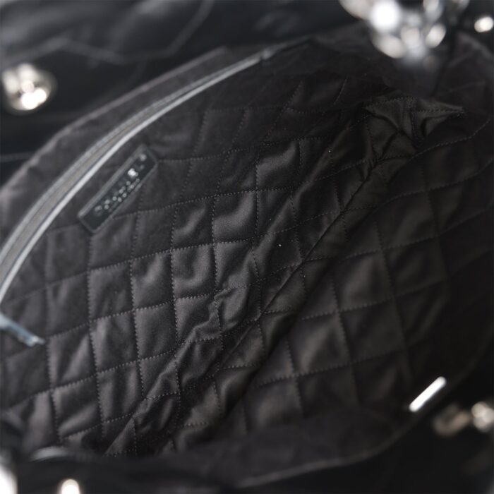 The interior is lined in black fabric with one zip pocket on the rear wall.