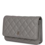 The interior is lined in grey leather and fabric and features a top zipper pocket under flap