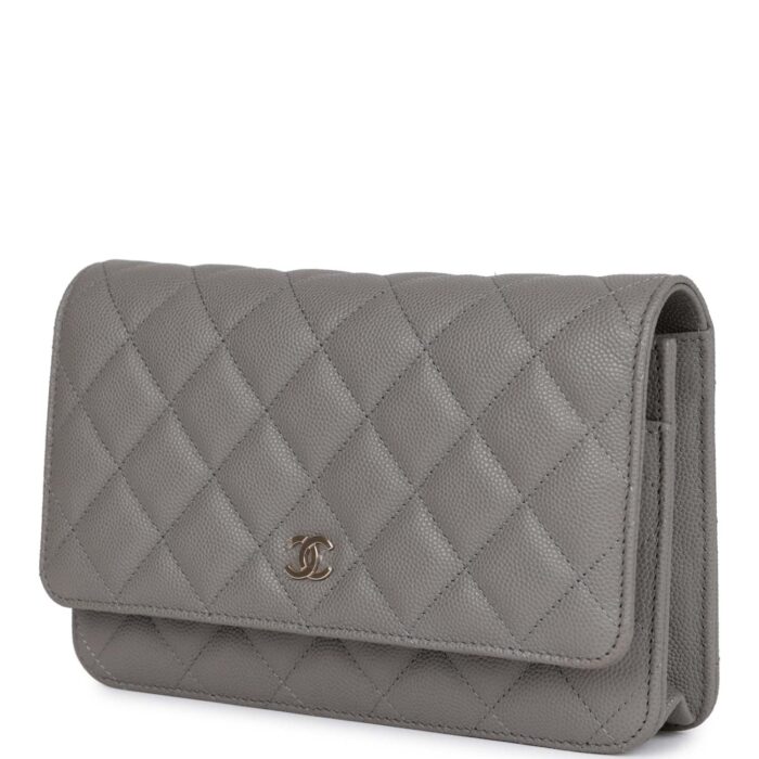 The interior is lined in grey leather and fabric and features a top zipper pocket under flap