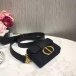 this box bag exudes an elegant and timeless style that is perfect for any occasion.The bag features a flap closure adorned with a unique ‘CD’ clasp in shiny antique gold