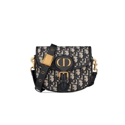 Experience the timeless elegance of the Christian Dior Small Dior Bobby Bag in Blue Dior Oblique Jacquard M9317. This exquisite hobo-style bag boasts a stunning design crafted from luxurious blue Dior Oblique jacquard canvas. The antique gold-finish hardware adds a touch of sophistication to its overall look.Measuring at 18 x 14 x 5 cm