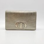 Crafted of gold patent leather Features an adjustable belt strap