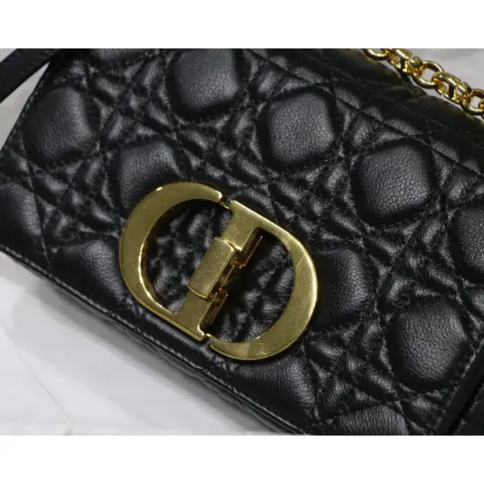 inspired by the seal of a Christian Dior perfume bottle. This intricate detail adds a touch of elegance to the bag.The bag comes with a removable signature ‘CD’ chain link shoulder strap that can be replaced with a wide embroidered strap. This versatility allows you to transition effortlessly from day to night