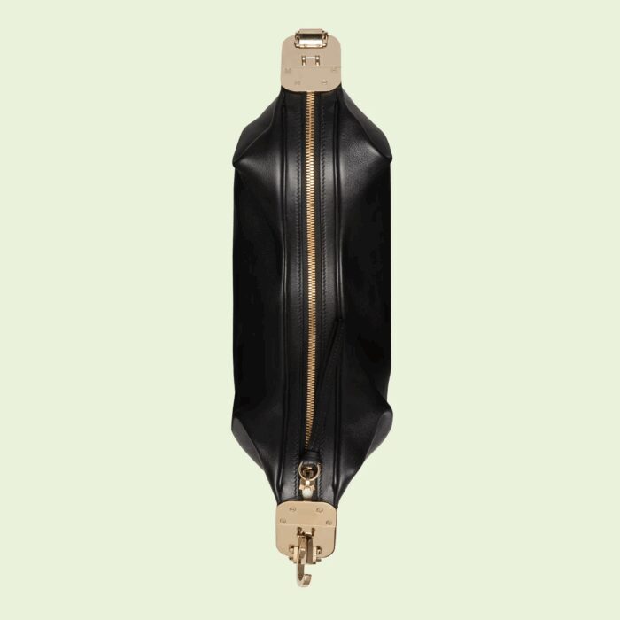 classic elements from the House's archives are reintroduced. Distinguished by its crescent moon shape