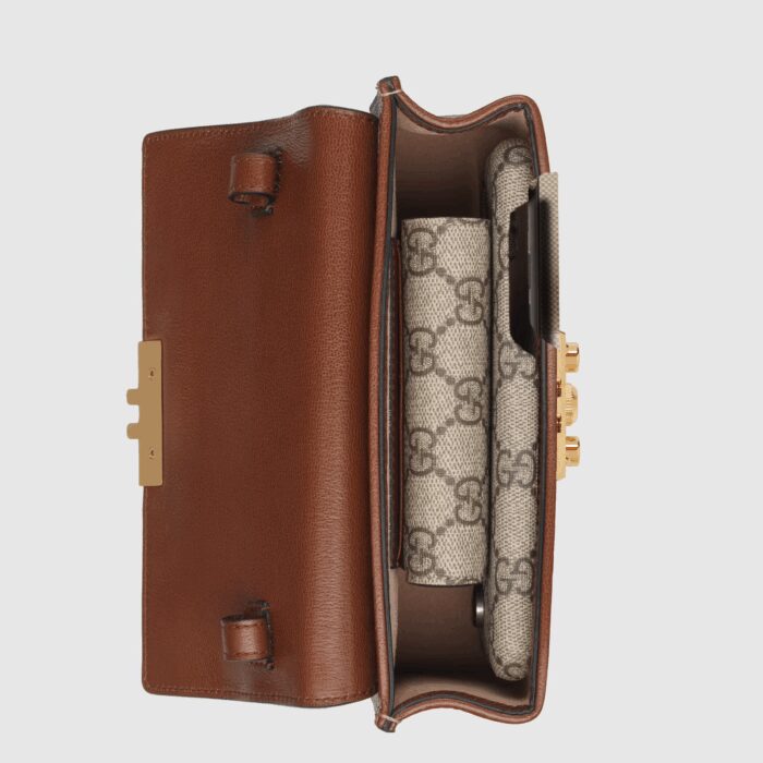 the style is crafted from the House's monogram canvas and accentuated by a black leather top. Adding to the styles contrasting elements