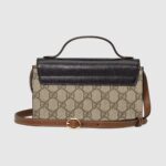 is a brown leather shoulder strap and handle. Playing with different materials and shades