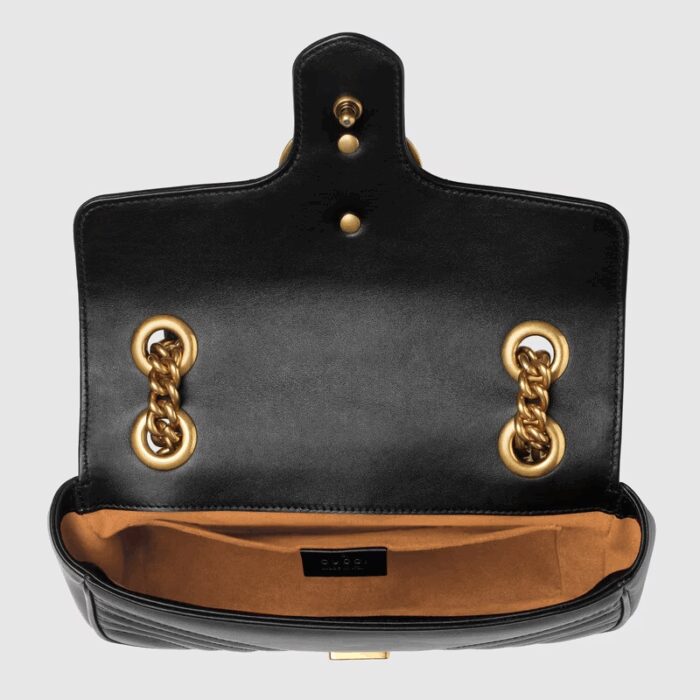 changing between a shoulder and a top handle bag. Made in matelassé chevron leather with a heart on the back.