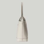 presented across an white leather base.