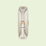 combining vintage elements with archival codes or contemporary details to create new designs that exist outside of space and time. The petite accessory reflects this fascination with the past