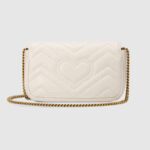 The GG Marmont mini bag in white matelassé leather is defined by its softly structured shape and a flap closure. The Double G defines the line
