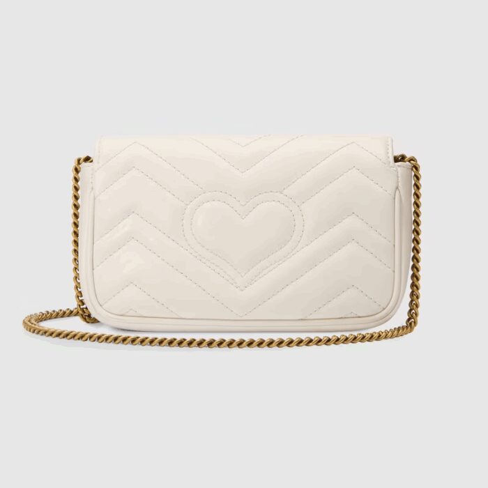 The GG Marmont mini bag in white matelassé leather is defined by its softly structured shape and a flap closure. The Double G defines the line