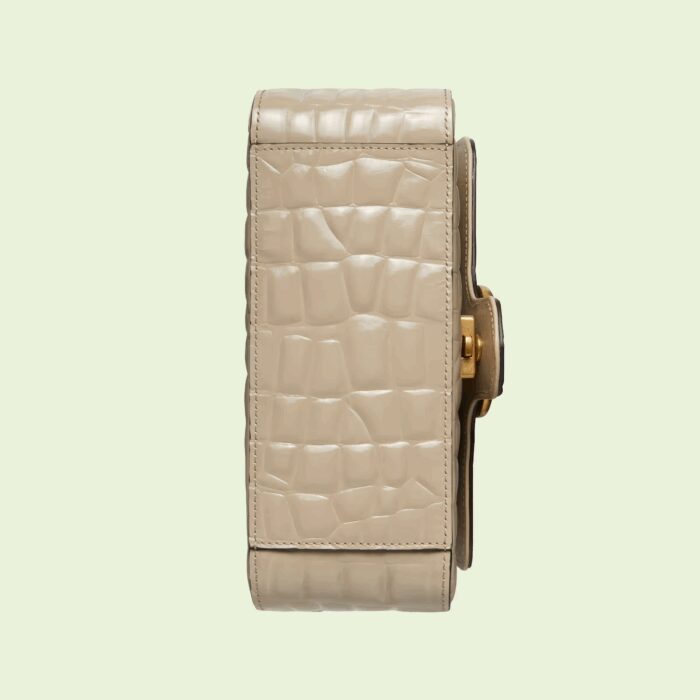 sans-serif; font-size: 12px; vertical-align: baseline; color: #4b4b4b; background-color: #ffffff;">The GG Marmont collection is defined by the emblematic Double G hardware—a contemporary take on a Gucci archival belt buckle from the '70s that has become a hallmark of the House. The mini top handle bag is presented in precious crocodile leather in a soft tone.