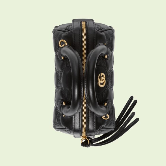 the signature material is reimagined once again as a part of Gucci Love Parade with a textured geometric motif. The design presents a contemporary approach to the '90s logo trend that appears throughout the House's latest collections. This shoulder bag is presented in a deep shade of black with three interchangeable straps.