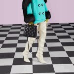 including this black leather top handle mini bag. The Double G hardware decorates the front