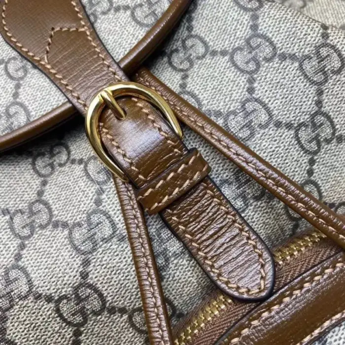 is complemented by brown leather trim and gold-toned hardware