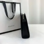 showcasing the brand’s timeless aesthetic. The pouch also includes a convenient open pocket for additional storage options.To keep your belongings secure