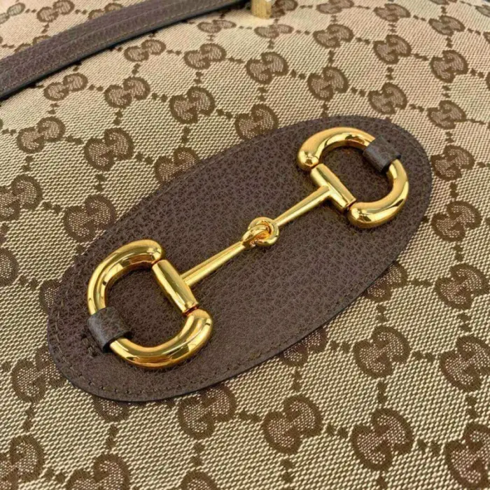 creating a seamless contrast that enhances its overall aesthetic. The gold-toned hardware further elevates its elegance