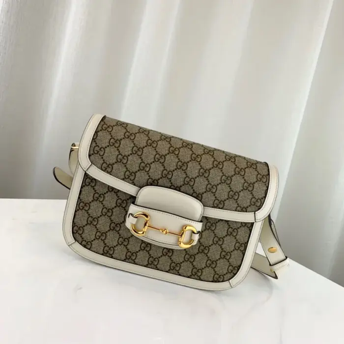 which is made with low environmental impact. The bag is accented with brown leather trim and gold-toned hardware.Inside