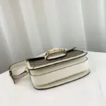 as well as a half Horsebit detail on each side. The bag has three gussets