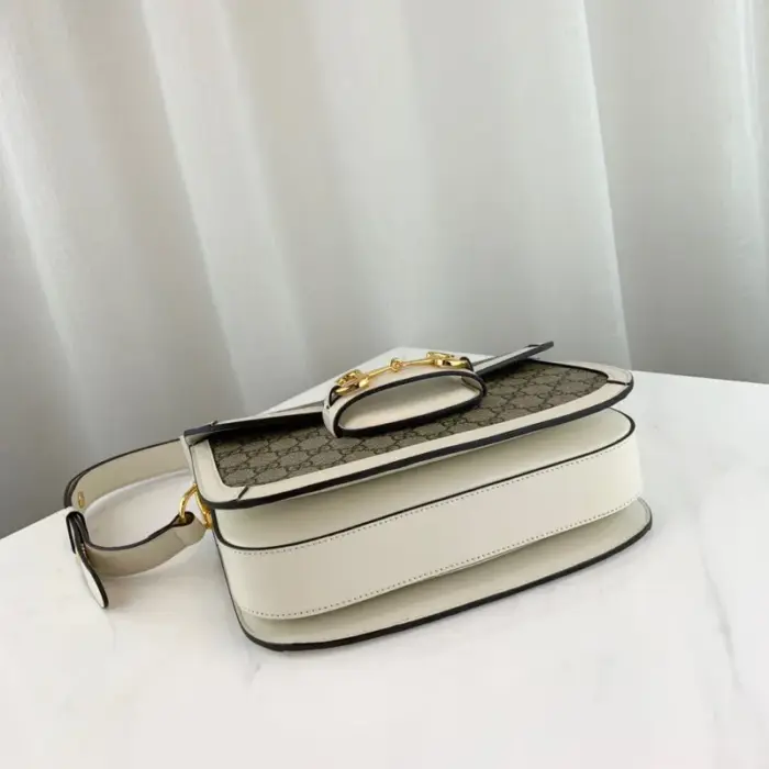 as well as a half Horsebit detail on each side. The bag has three gussets