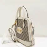and 3.5 inches deep. This exquisite bag features a domed shape with a detachable leather shoulder strap