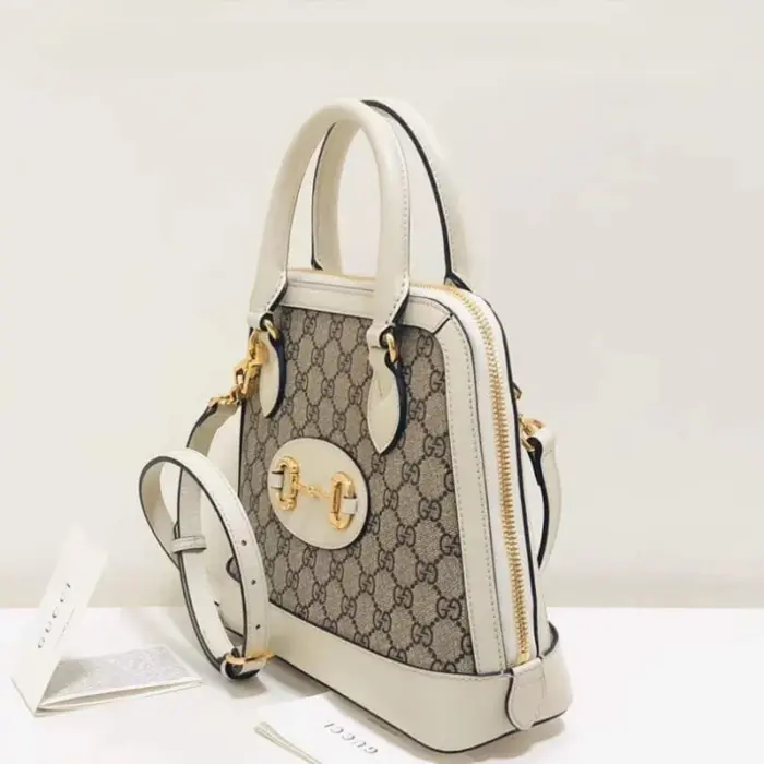 and 3.5 inches deep. This exquisite bag features a domed shape with a detachable leather shoulder strap
