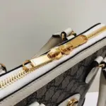 created with GG Supreme canvas and adorned with elegant white leather accents.Pay homage to the timeless design of the original bag that inspired this collection