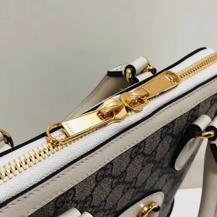 created with GG Supreme canvas and adorned with elegant white leather accents.Pay homage to the timeless design of the original bag that inspired this collection