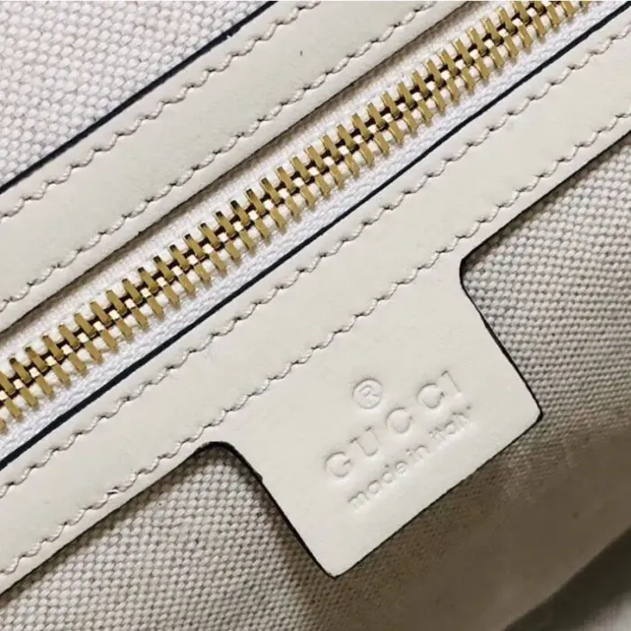you will find both a zipper pocket and open pockets to keep your belongings organized. The bag comes with leather top handles