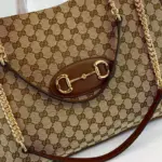 is prominently featured on the front of the bag. This double ring and bar design is borrowed from the equestrian world and has become one of the most recognizable Gucci symbols.Measuring 16.5 inches in width