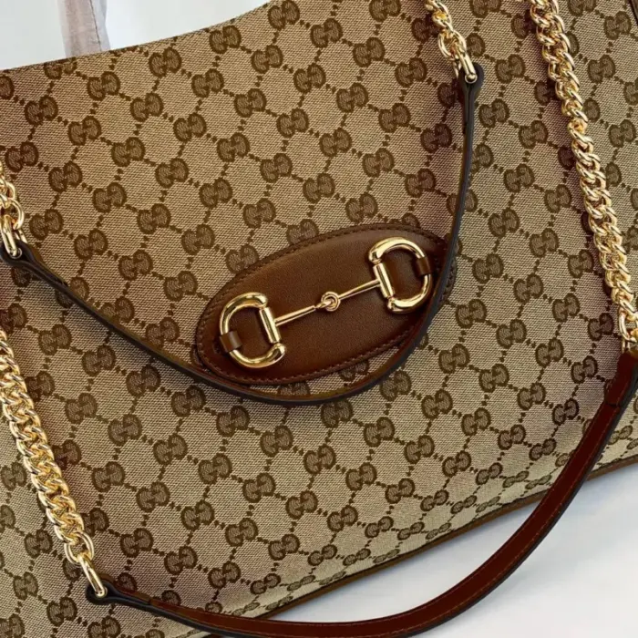 is prominently featured on the front of the bag. This double ring and bar design is borrowed from the equestrian world and has become one of the most recognizable Gucci symbols.Measuring 16.5 inches in width