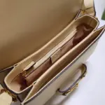 the bag comes with a small pouch containing two button covers. These covers can be used to conceal the exposed studs when the shoulder strap is lengthened.The bag also boasts the iconic Horsebit detail at the front