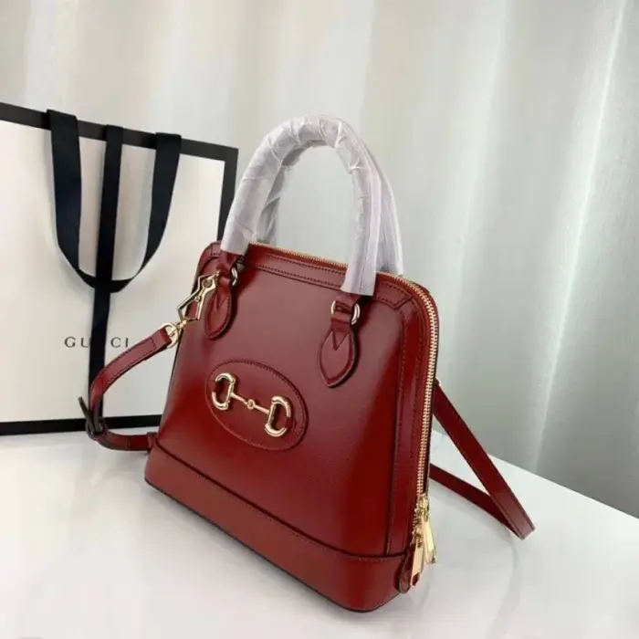 this bag features a unique domed shape and comes crafted from exquisite white leather. It also comes with a convenient optional leather shoulder strap.This collection pays homage to the original bag that inspired it