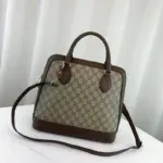 adding a luxurious touch to the design.One of the standout elements of this bag is the contrasting BOUTIQUE lettering displayed atop the GG Supreme printed canvas. This contemporary detail reflects the current trend of incorporating slogans into fashion