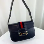 which has become synonymous with the Gucci brand. The Horsebit hardware is paired with the distinctive House Web stripe on blue leather