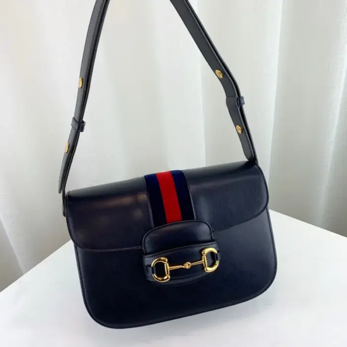 which has become synonymous with the Gucci brand. The Horsebit hardware is paired with the distinctive House Web stripe on blue leather