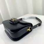 the bag is made of blue leather and adorned with gold-toned hardware. The interior is lined with microfiber material that has a suede-like finish